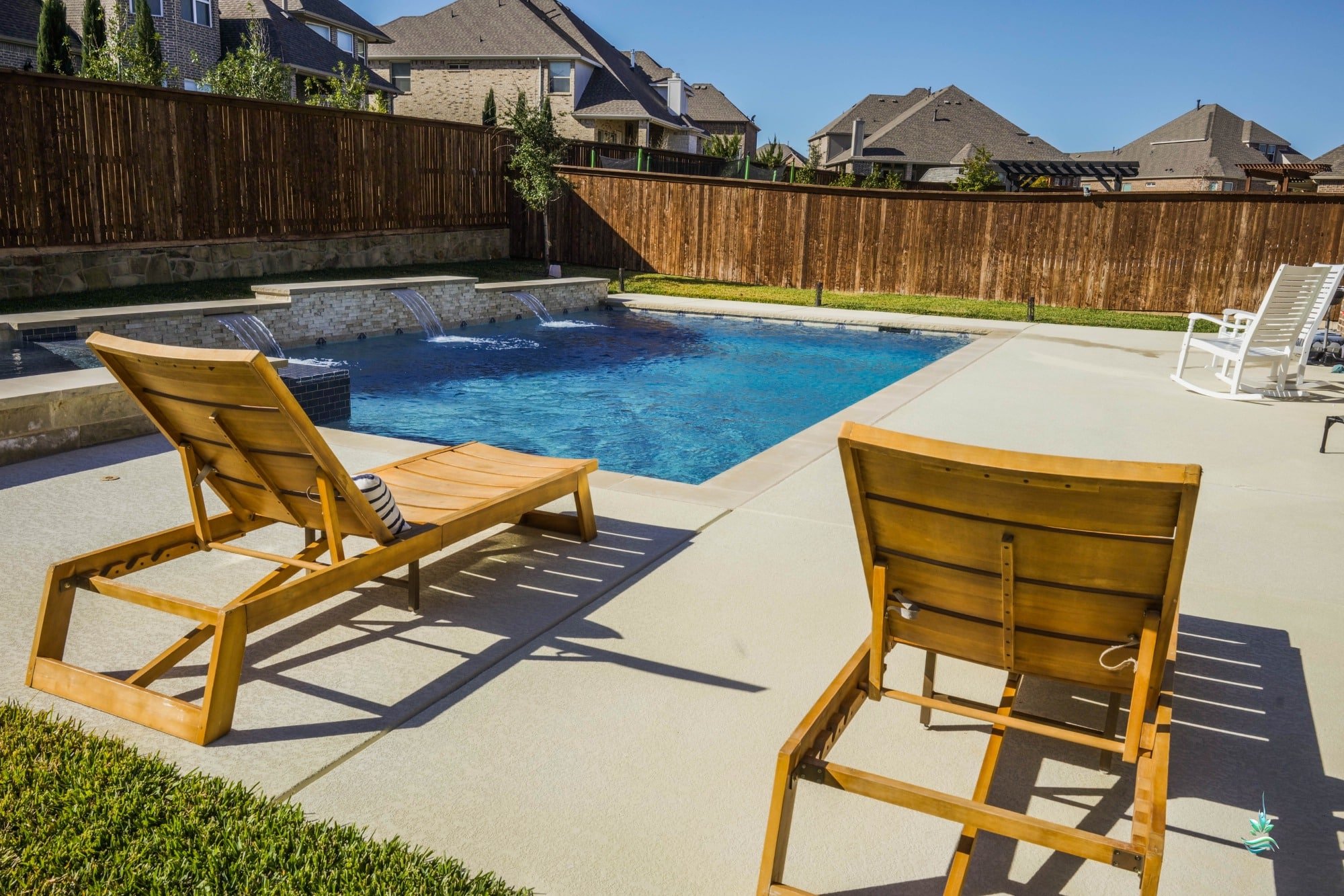 Outdoor pool deck with Adirondack chairs